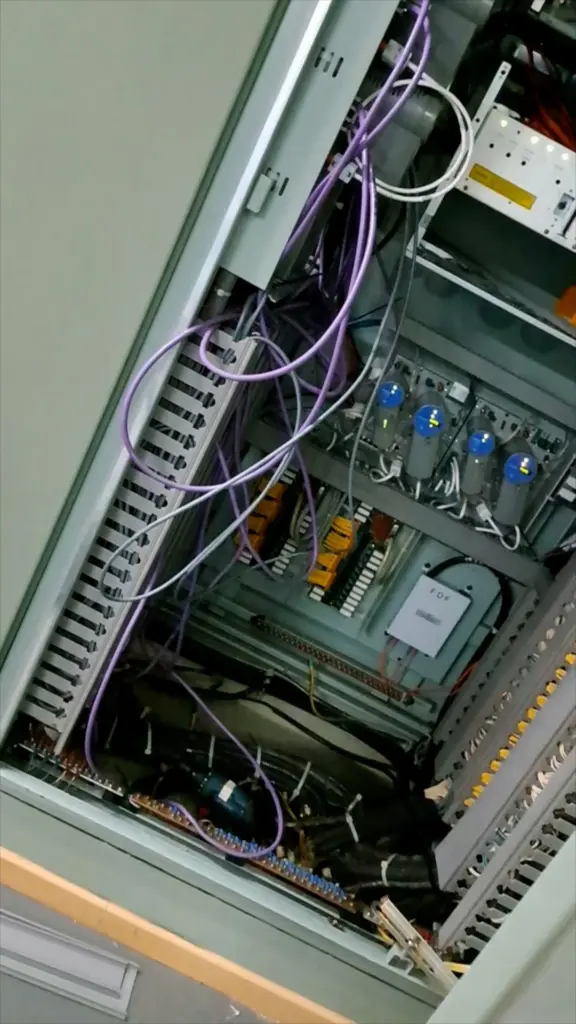 Control cabinet opened for fault-finding, wiring and modules visible