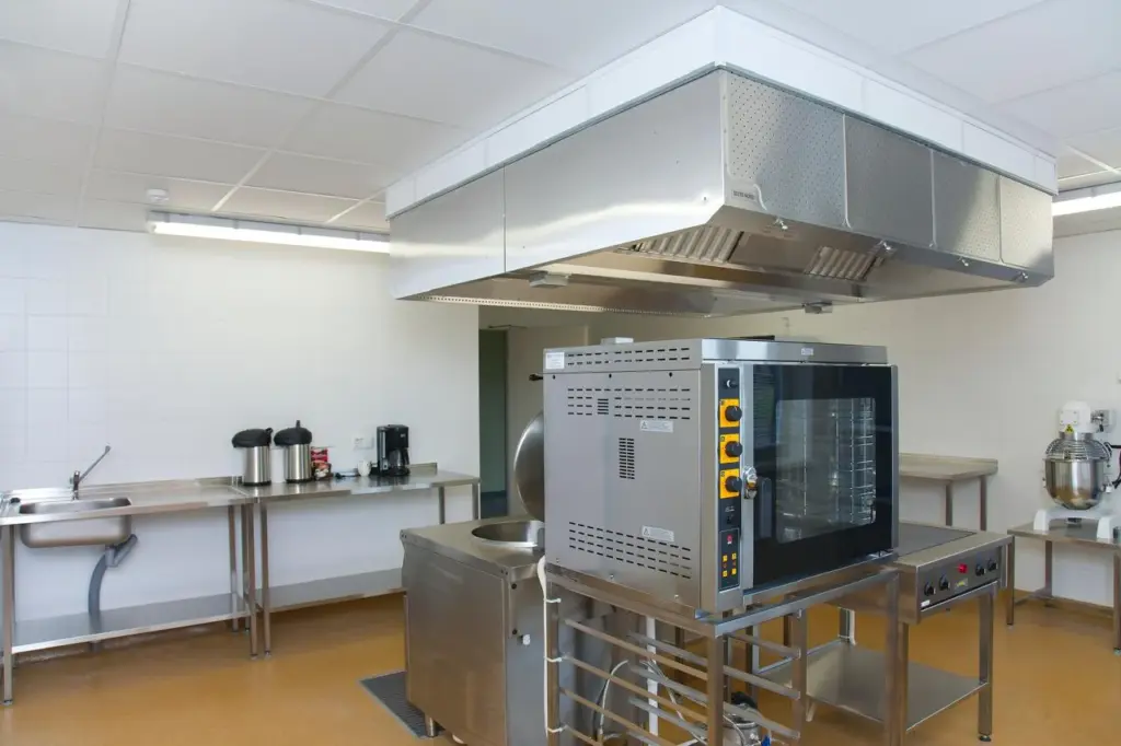 Commercial galley with a combi oven, extraction canopy, bratt pan and planetary mixer